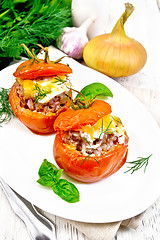 Image showing Tomatoes stuffed with meat and rice in plate on board