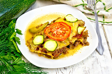 Image showing Casserole from minced meat and zucchini in plate on table