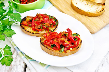 Image showing Bruschetta with tomatoes and peppers in plate on light board