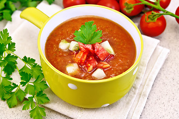 Image showing Soup tomato in yellow bowl on stone table