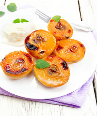 Image showing Quince baked with ice-cream in plate on towel