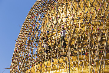 Image showing Worker repareing golden temple