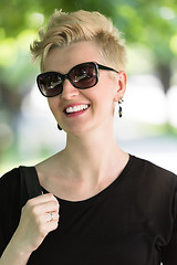 Image showing young woman with short blond hair and sunglasses