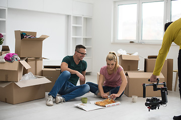 Image showing young couple have a pizza lunch break on the floor