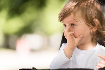 Image showing baby girl sitting in the pram