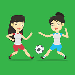 Image showing Two female soccer players fighting for ball.