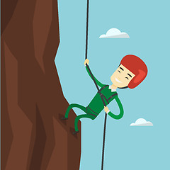 Image showing Man climbing in mountains with rope.