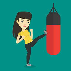 Image showing Woman exercising with punching bag.