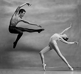 Image showing Couple of ballet dancers posing over gray background