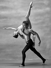 Image showing Couple of ballet dancers posing over gray background