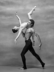 Image showing Couple of ballet dancers posing over gray background