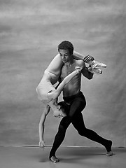 Image showing Couple of ballet dancers posing over gray background