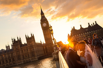 Image showing Street scene of random people on Westminster Bridge in sunset, London, UK.