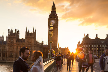 Image showing Traffic and random people on Westminster Bridge in sunset, London, UK.