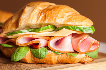 Image showing Croissants sandwiches on the wooden cutting board