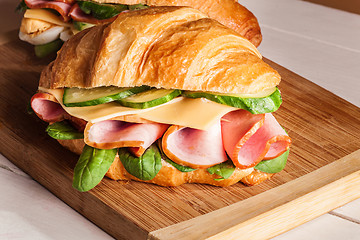 Image showing Croissants sandwiches on the wooden cutting board