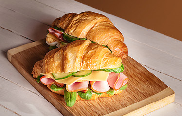 Image showing Croissants sandwiches on the wooden cutting board