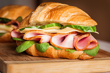 Image showing Croissants sandwiches on the wooden cutting board