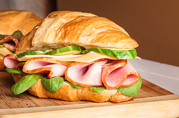 Image showing Croissants sandwiches on the wooden cutting board