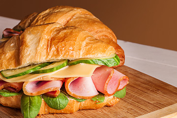 Image showing Croissants sandwiches on the wooden cutting board