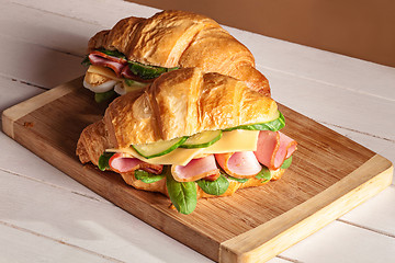 Image showing Croissants sandwiches on the wooden cutting board