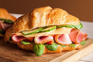 Image showing Croissants sandwiches on the wooden cutting board