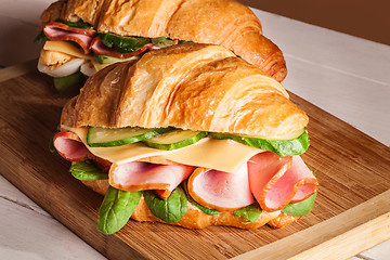 Image showing Croissants sandwiches on the wooden cutting board