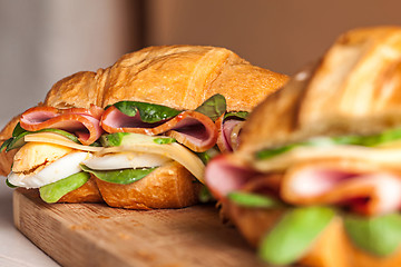 Image showing Croissants sandwiches on the wooden cutting board