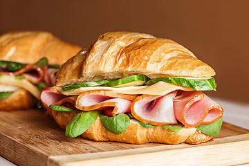 Image showing Croissants sandwiches on the wooden cutting board