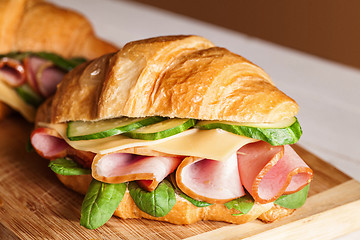 Image showing Croissants sandwiches on the wooden cutting board