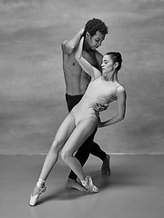 Image showing Couple of ballet dancers posing over gray background