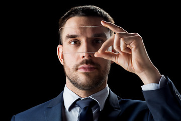 Image showing businessman with transparent smartphone
