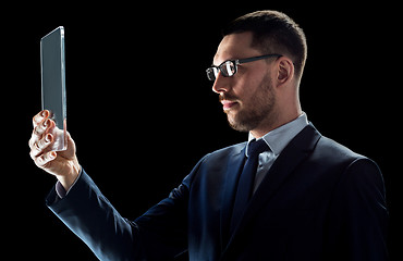 Image showing businessman in suit with transparent tablet pc