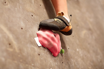 Image showing foot of woman on indoor climbing gym wall hold