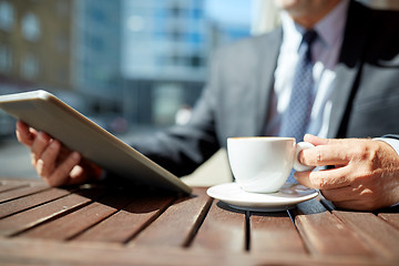 Image showing senior businessman with tablet pc and coffee