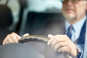 Image showing senior businessman hands driving car