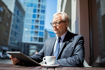 Image showing senior businessman with tablet pc drinking coffee