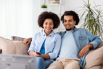 Image showing happy smiling couple watching tv at home