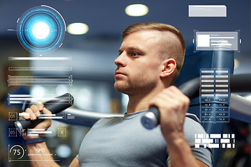 Image showing man exercising and flexing muscles on gym machine