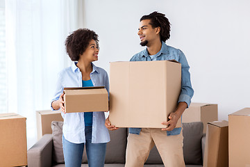 Image showing happy couple with boxes moving to new home