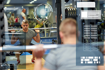 Image showing young man flexing muscles with barbell in gym