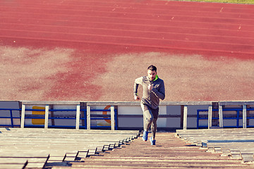 Image showing man running upstairs on stadium