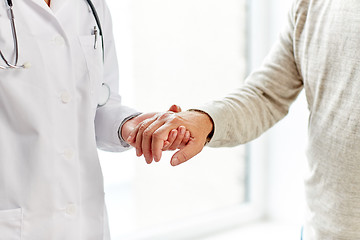 Image showing close up of doctor holding old man hand