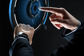 Image showing close up of businessman hands with smartwatch