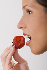 Image showing Biting into a strawberry