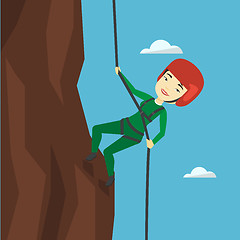 Image showing Woman climbing in mountains with rope.