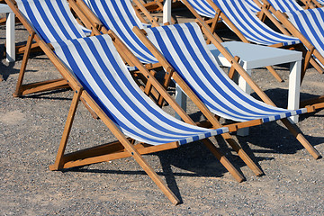 Image showing blue and white chaise longues