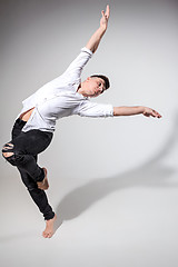 Image showing The young man dancing on gray