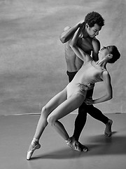 Image showing Couple of ballet dancers posing over gray background