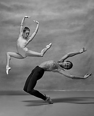 Image showing Couple of ballet dancers posing over gray background